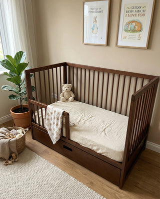 two toddlers in cot with teething rails attached